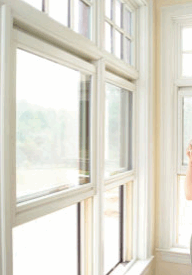 Woman looking out window drinking coffee