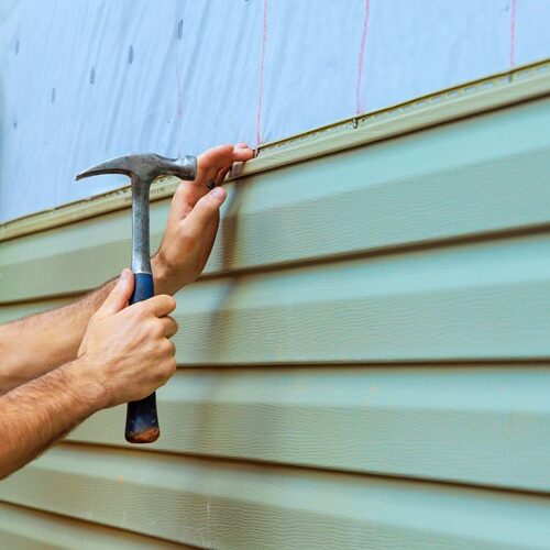 Man installing vinyl siding